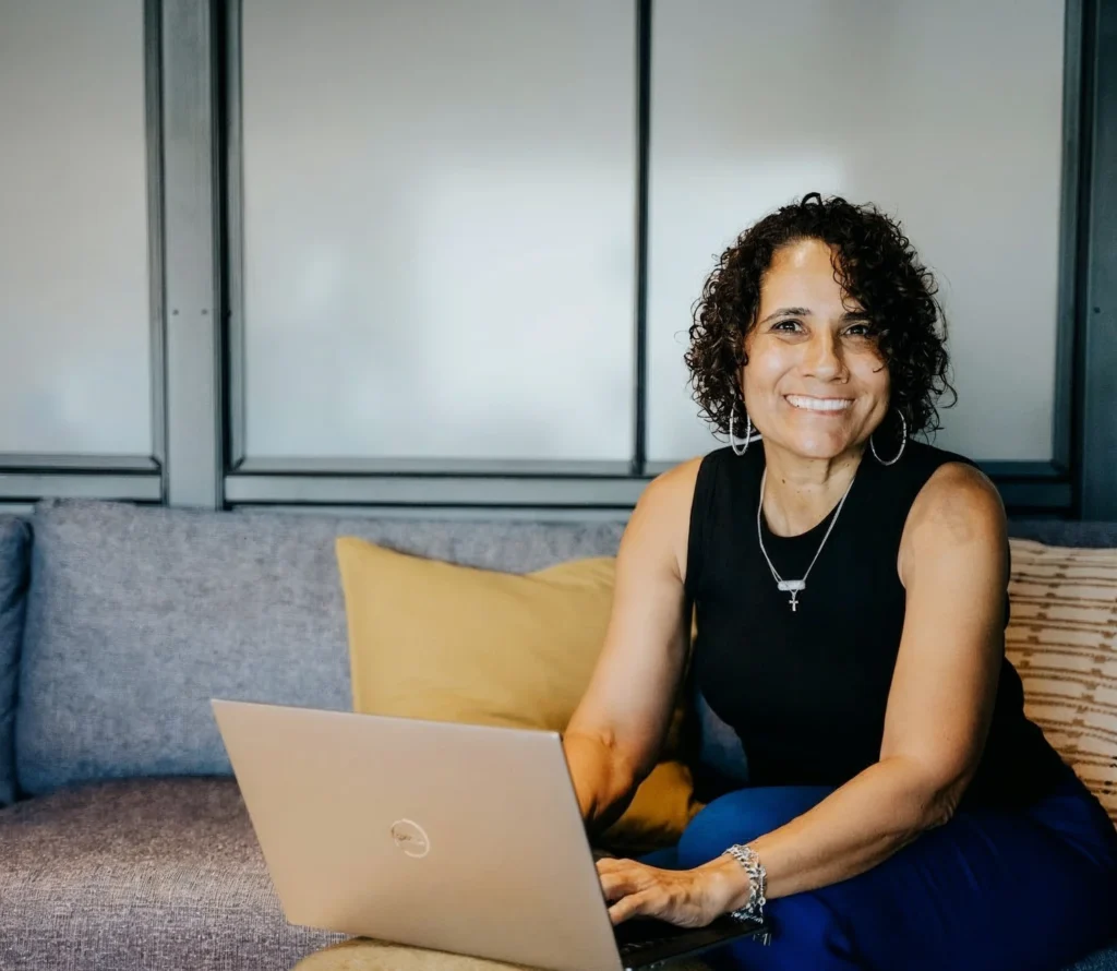 Dominique DelHomme at her laptop